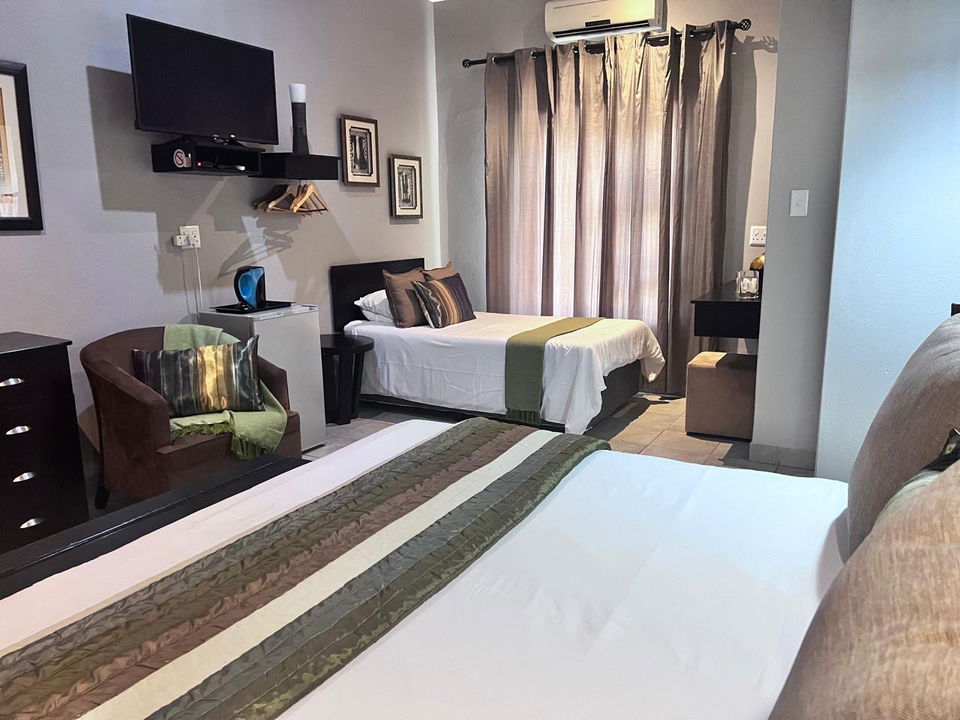  interior of luxury room with extra beds at secrets VIP safari lodge Komatipoort