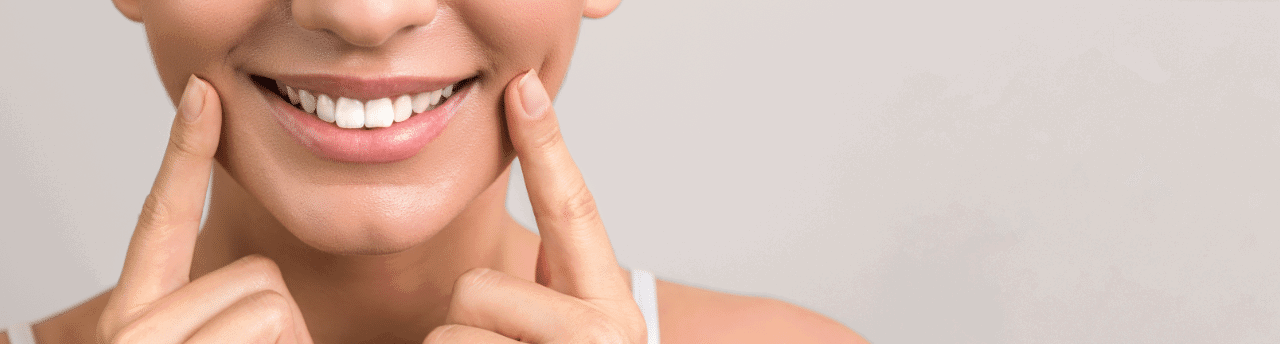 lady patient pointing to her mouth and smiling face