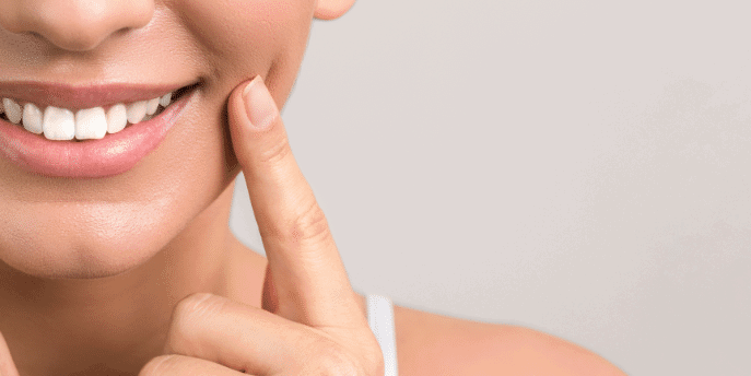 lady patient pointing to her mouth and smiling face