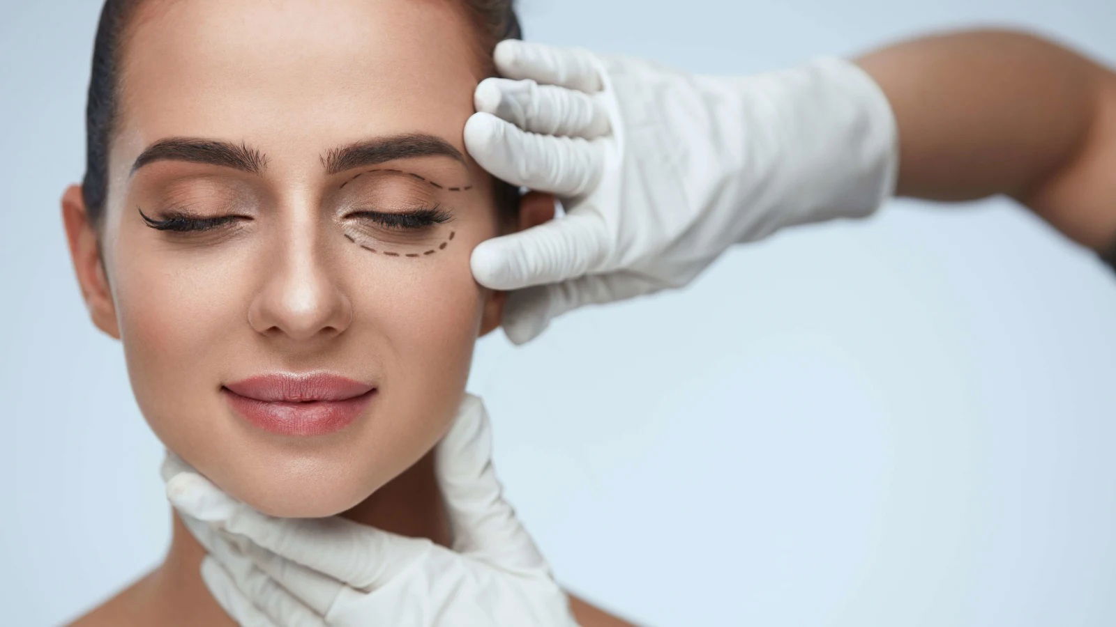 lady patient face with pencil lines for cosmetic surgery