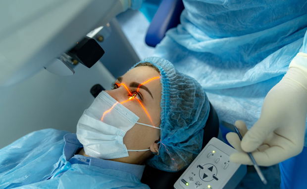 patient with cross laser light on eye waiting for ophthalmic surgery