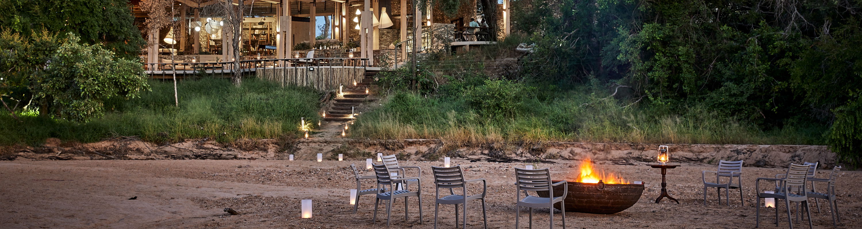Sunset view with fire and chairs in front of Thornybush Saseka tented camp safari lodge