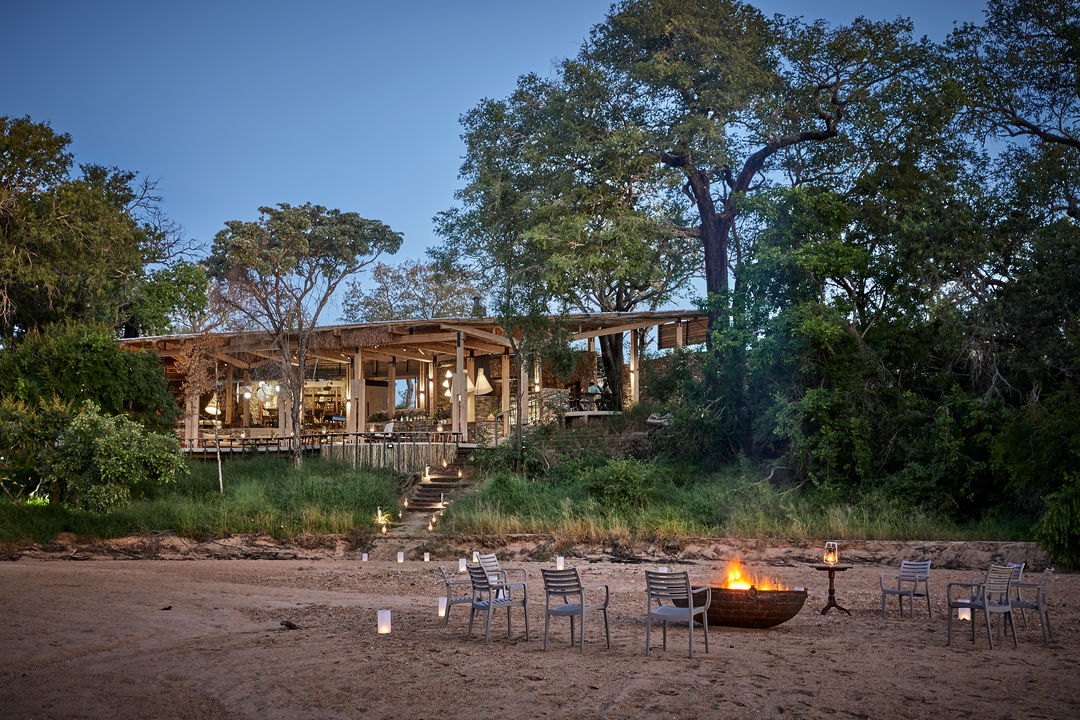 Sunset view with fire and chairs in front of Thornybush Saseka tented camp safari lodge