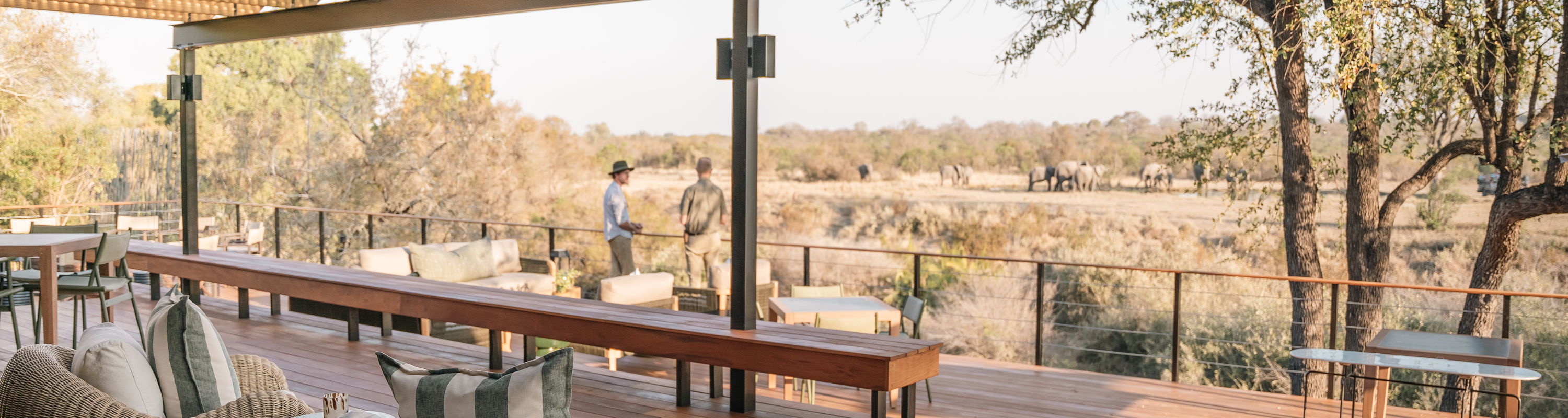 Main area and deck at Simbambili Thornybush luxury safari lodge with elephants in background