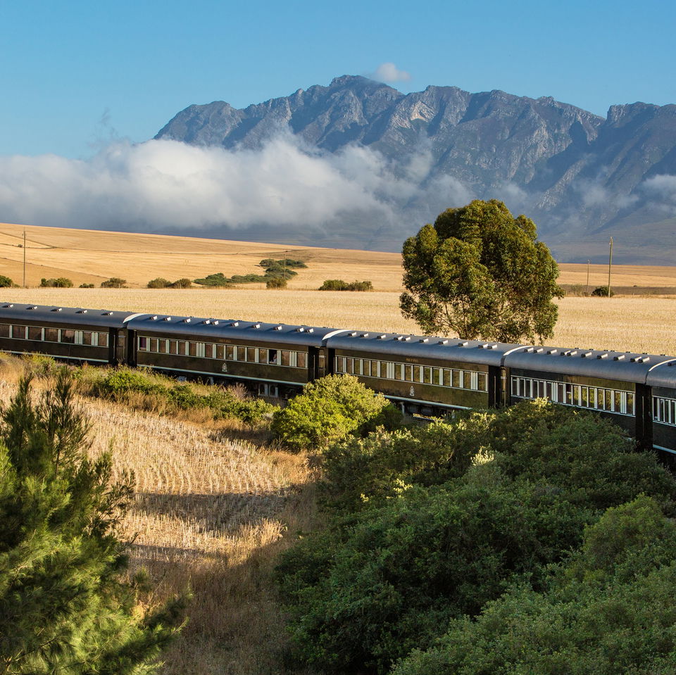  airiel view of rovos rail train ride through south Africa with mountain in backdrop