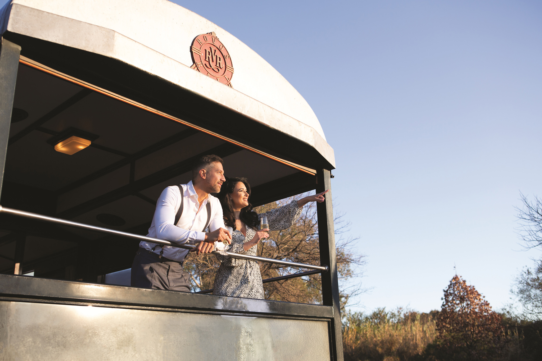 couple looking from back of train to the rear end at Rovos rail luxury train safaris