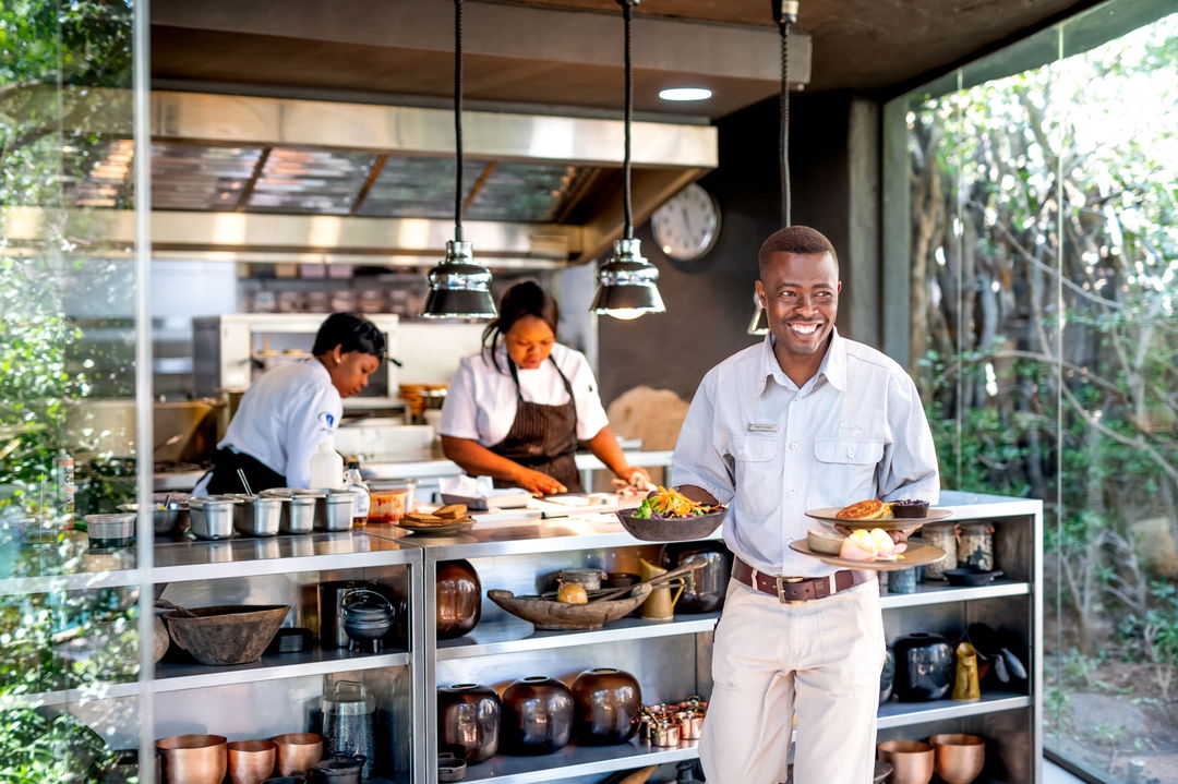staff serving food at singita boulders lodge