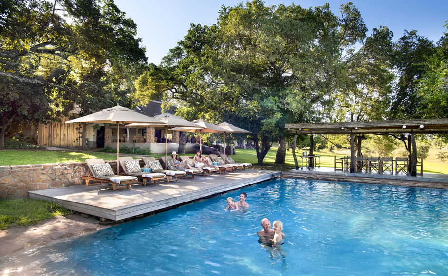 guests in pool of singita castleton lodge
