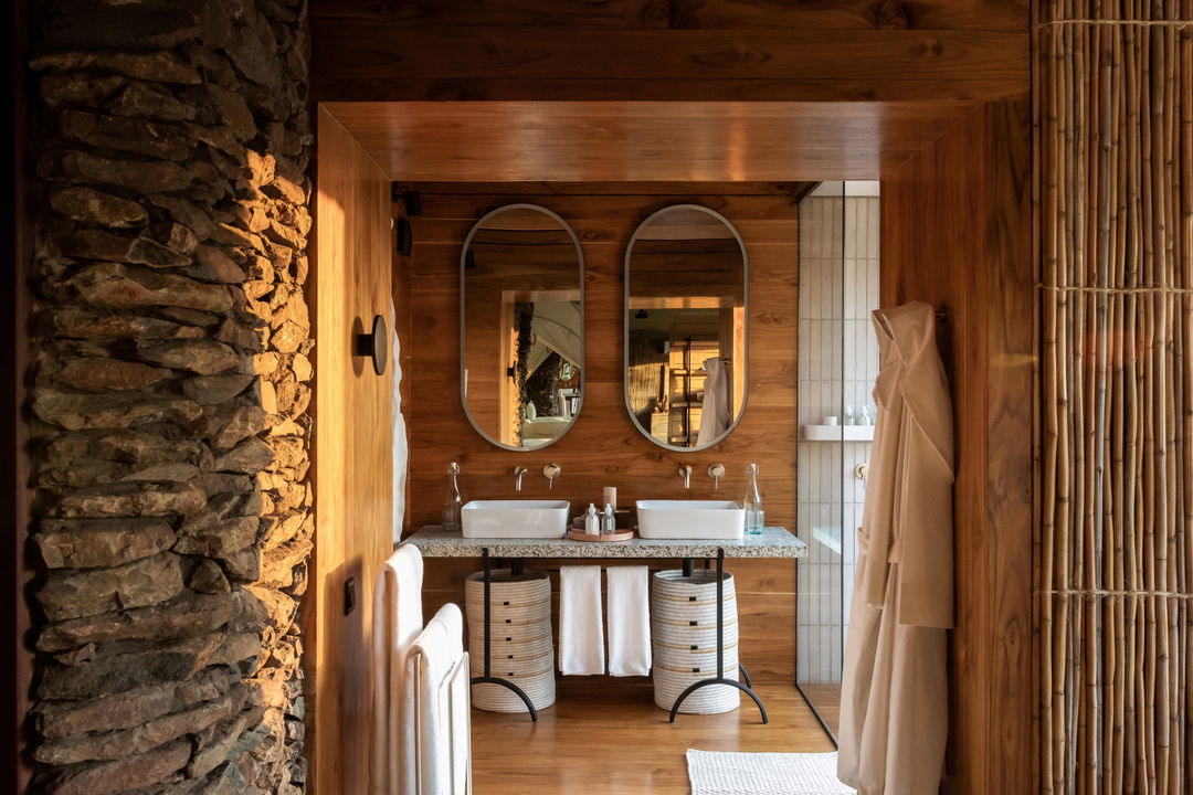 vanity and bathroom facilities of a suite bathroom at Singita Faru Faru lodge Serengeti