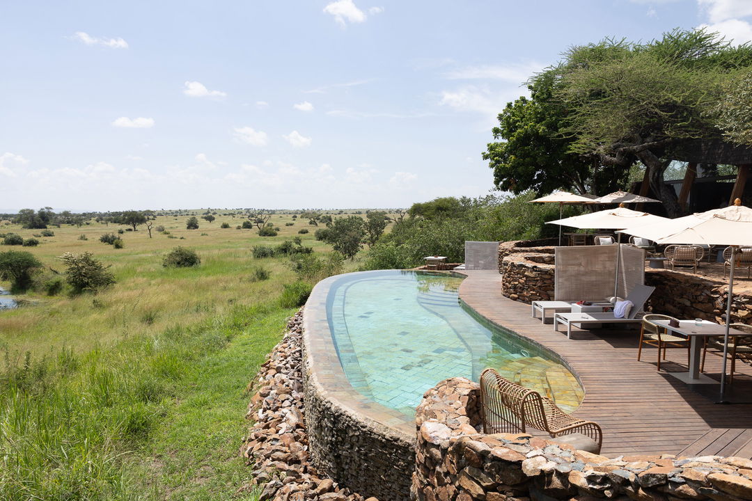 side view of the main rim pool with views at Singita Faru Faru lodge Serengeti