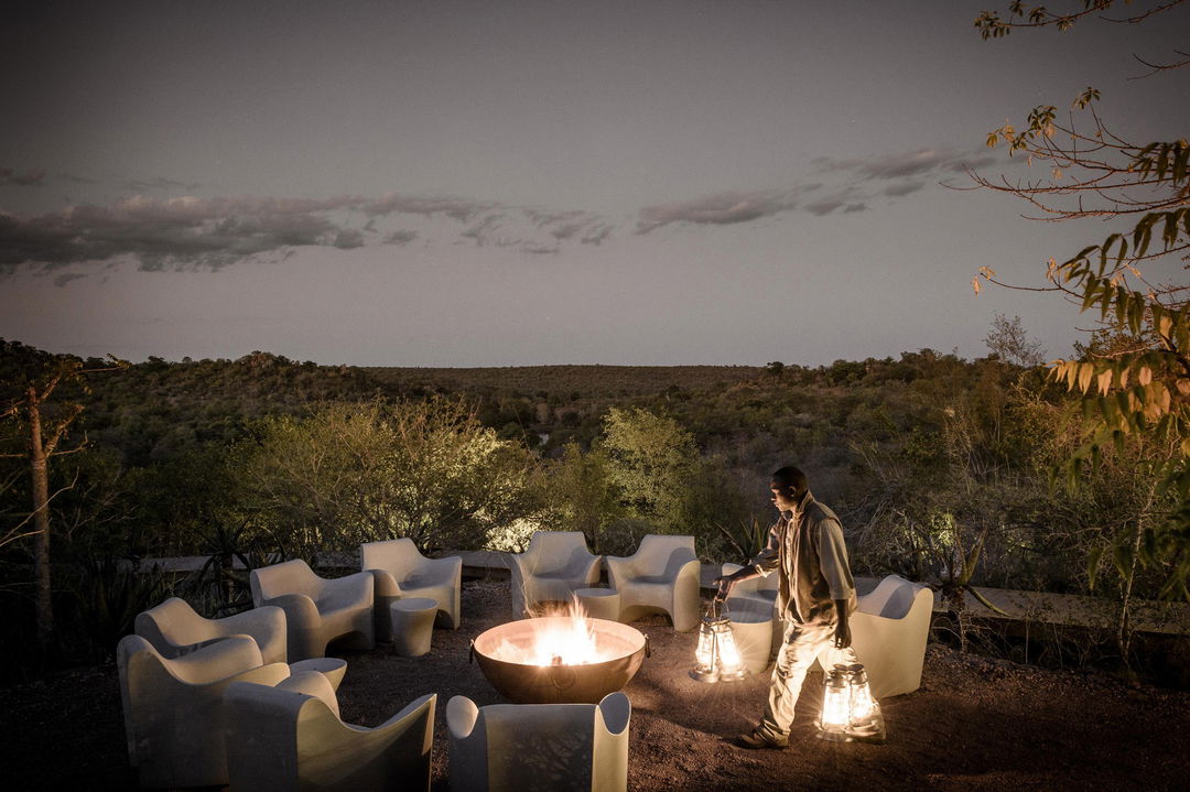 staff prepping for supper in the bush at singita lebombo lodge fire pit