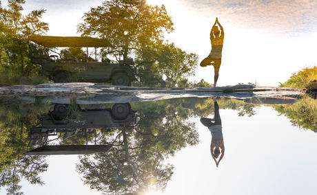 guest doing yaga by the river at singita guest doing yaga by the river at singita