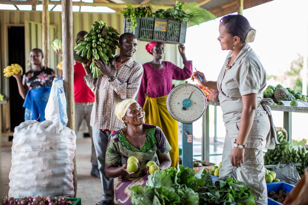 local produce market with staff buying fresh goods for Singita Sabora Tented Camp Serengeti 