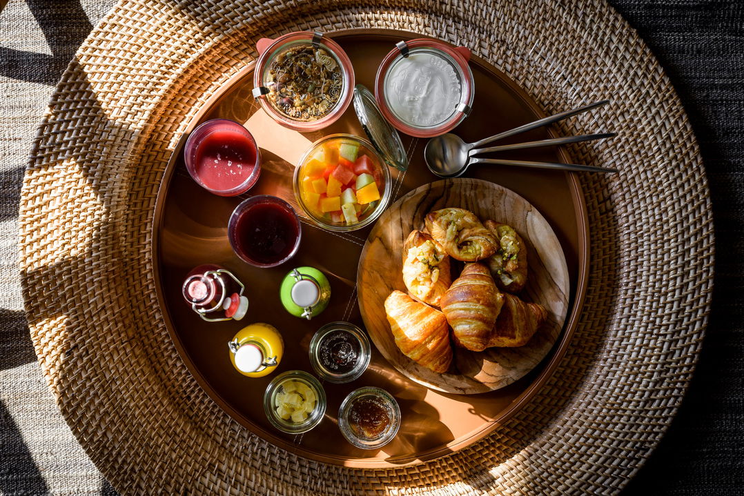 food and snacks plated on a wooden tray at Singita Sabora Tented Camp Serengeti 