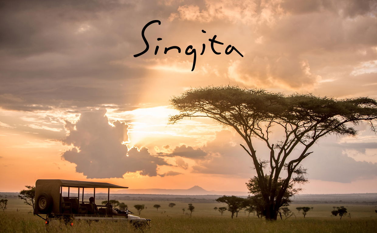Safari vehicle on plains at sunset by Singita Sabora Tented Camp Serengeti with logo overlay