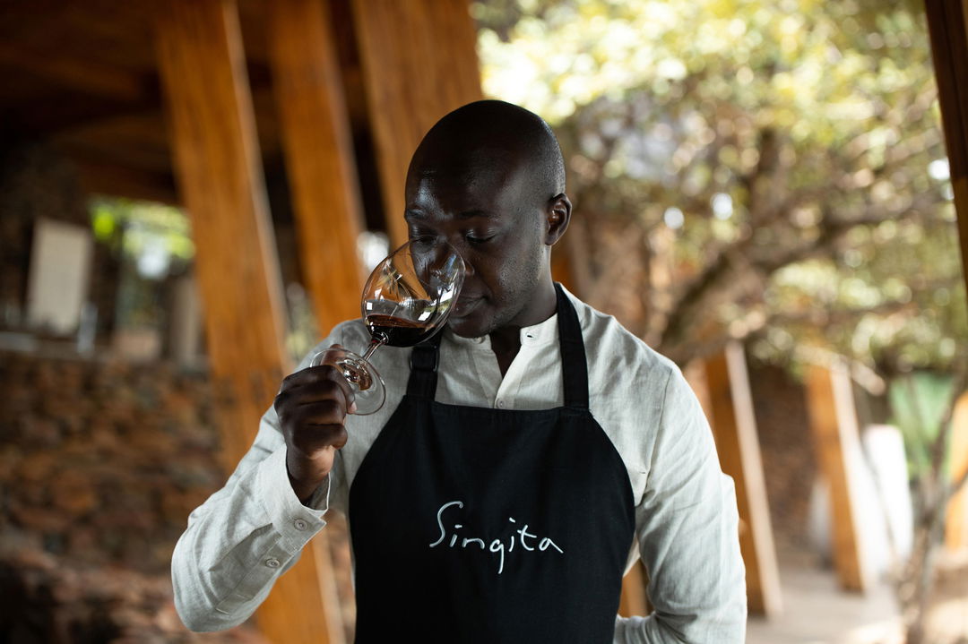 sommelier tasting wine at Singita Sabora Tented Camp Serengeti 