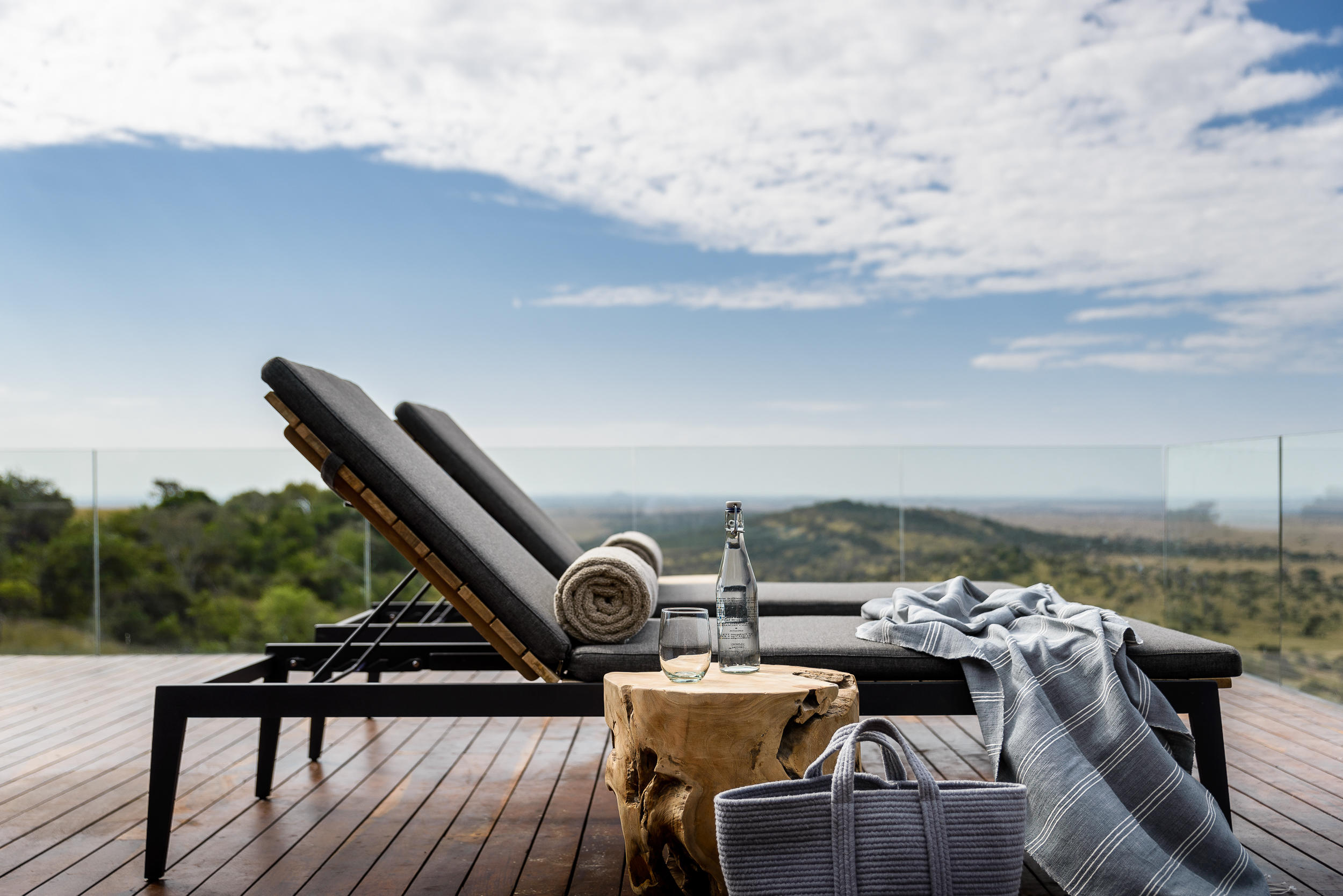 deckchairs on deck of hillside suite at Singita Sasakwa lodge in Serengeti
