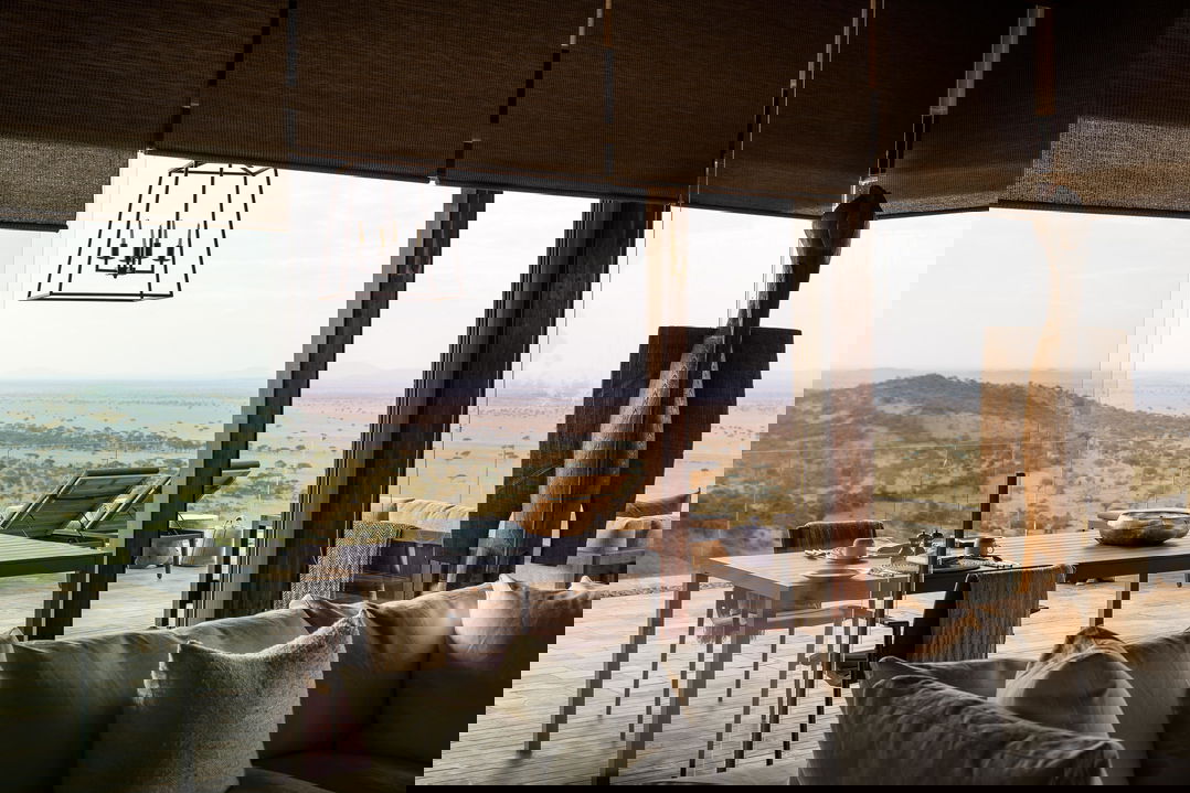 view of veranda and plains from lounge of hillside suite at Singita Sasakwa lodge in Serengeti