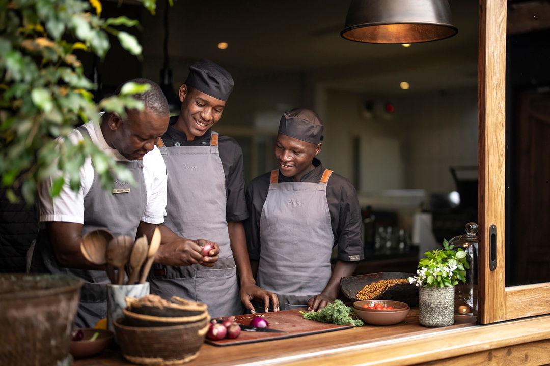 three chefs in the kitchen of Singita Sasakwa lodge in Serengeti
