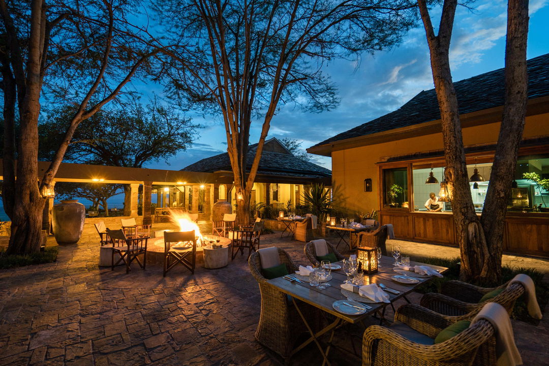evening dinner setting outside lodge at Singita Sasakwa lodge in Serengeti
