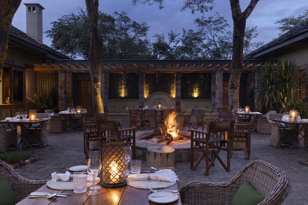 outside dining under candlelight at Singita Sasakwa lodge in Serengeti