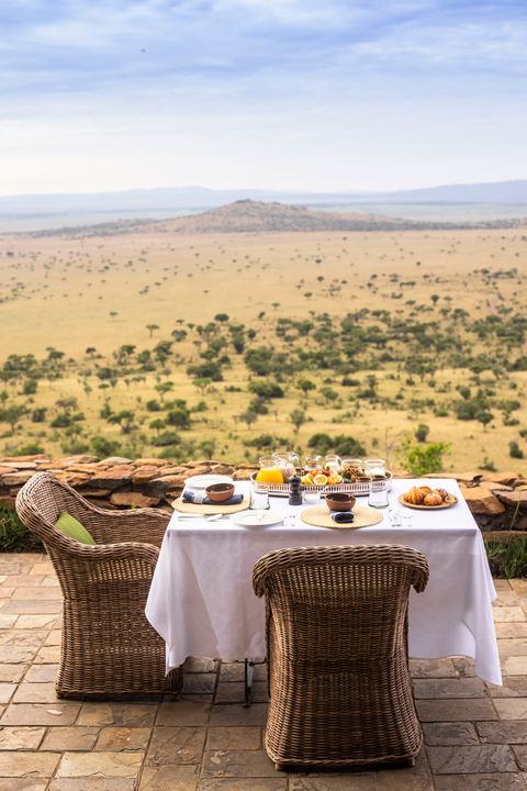 outdoor dining setting on the deck of Singita Sasakwa lodge in Serengeti