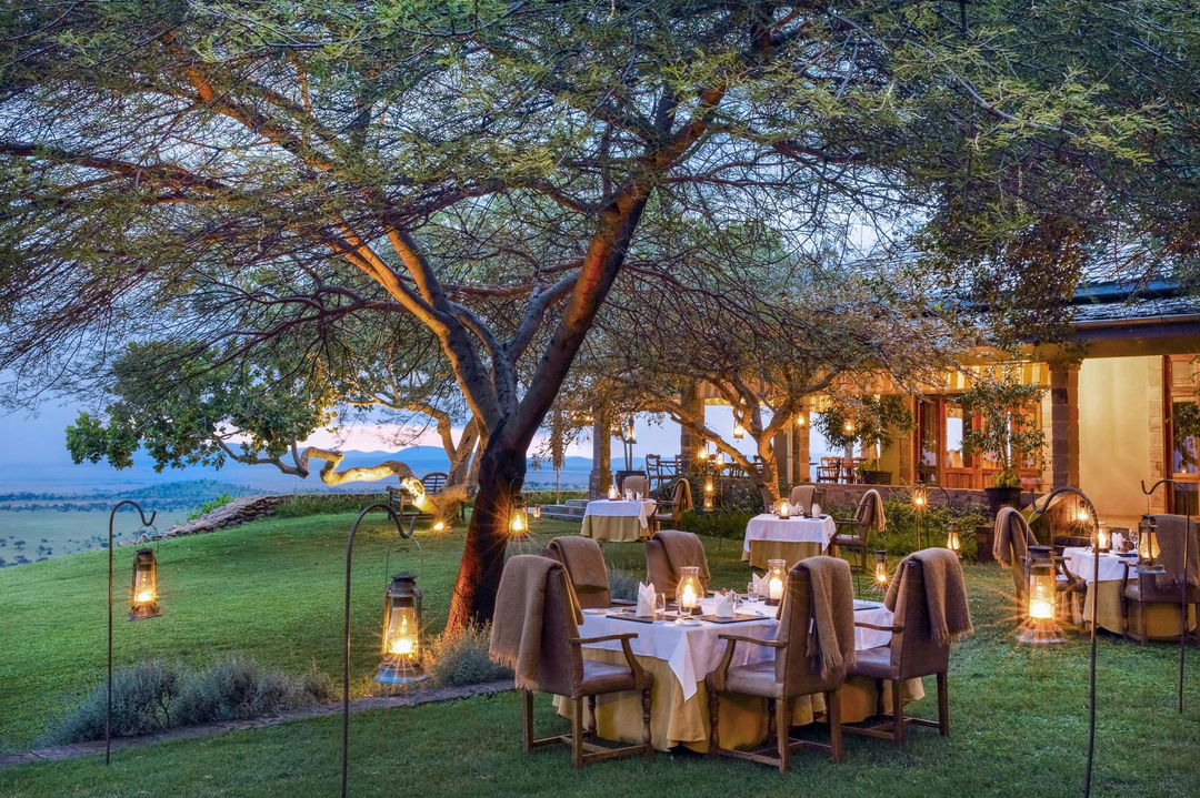 dining under stairs outside the main facility of Singita Sasakwa lodge in Serengeti