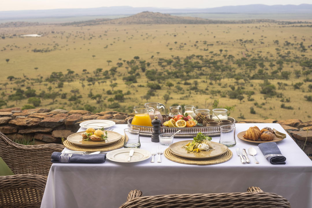 dining setting on viewing deck with plains below at Singita Sasakwa lodge in Serengeti