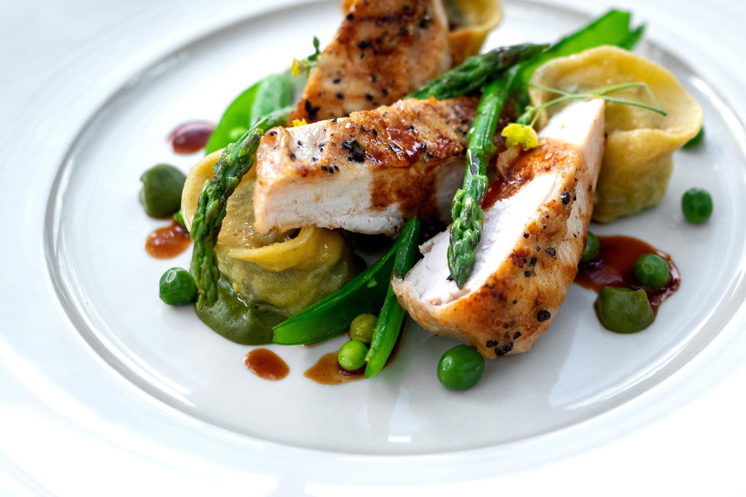 gourmet food on a white pate at Singita Sasakwa lodge in Serengeti
