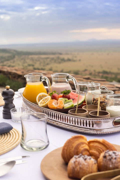 breakfast dining setting on viewing deck of Singita Sasakwa lodge in Serengeti