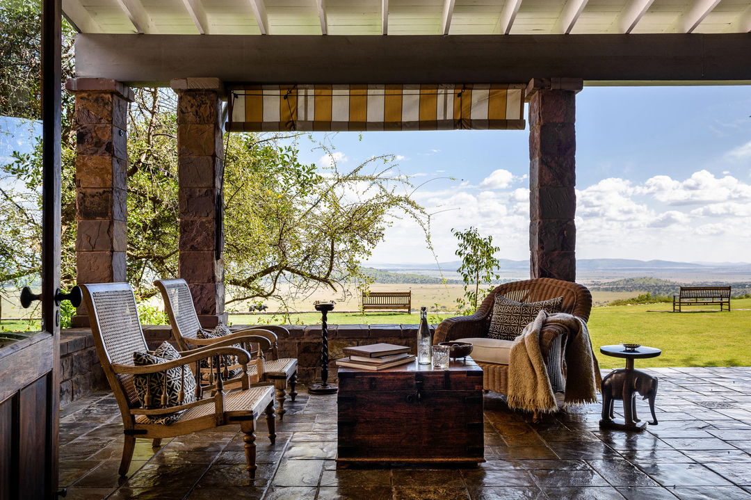 open verranda with furniture and views of plains at Singita Sasakwa lodge in Serengeti