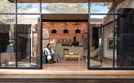 lady sitting in art gallery and boutique at singita lodges lady sitting in art gallery and boutique at singita lodges