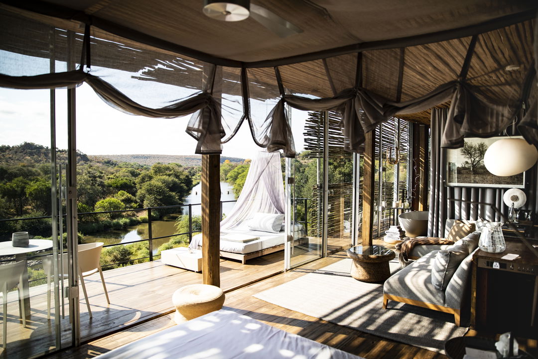 luxury room with river view and outside bed at Singita Lebombo lodge