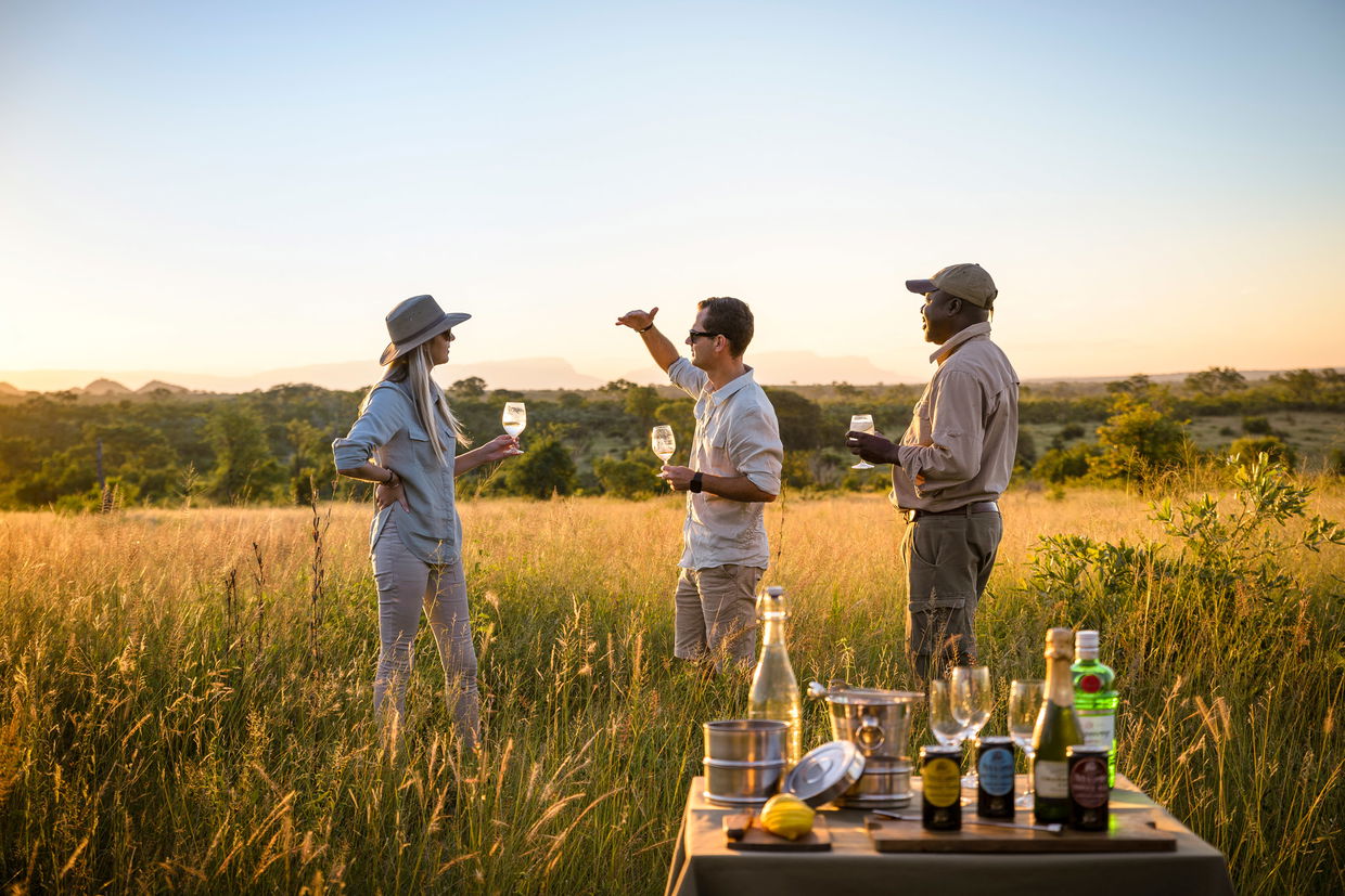 guests having sundowners with guide at singita lodge