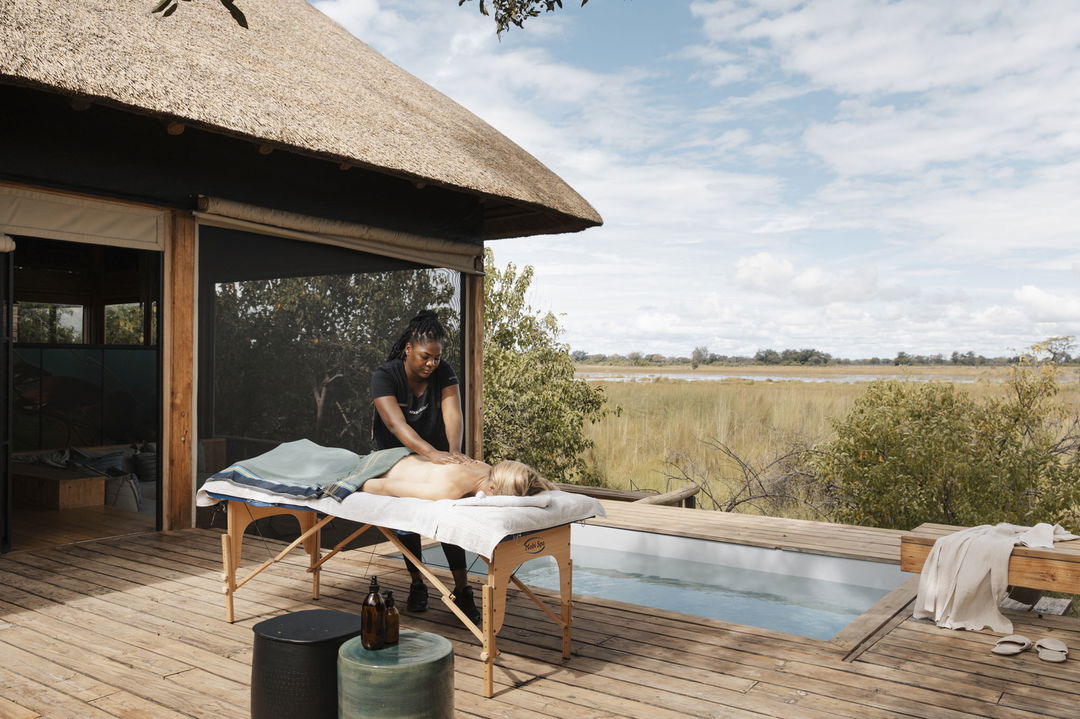 open air spa bed with guest getting a treatment at Vumbura Plains Camp Wilderness Okavango Delta