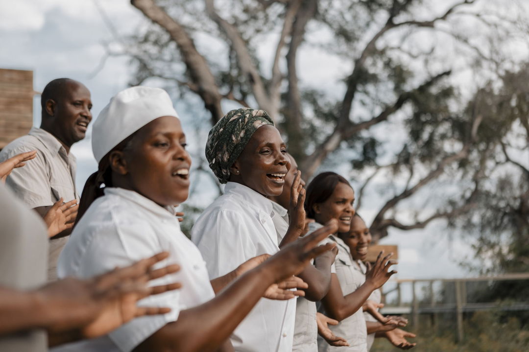 kitchen staff singing to guests at Vumbura Plains Camp Wilderness Botswana Okavango Delta