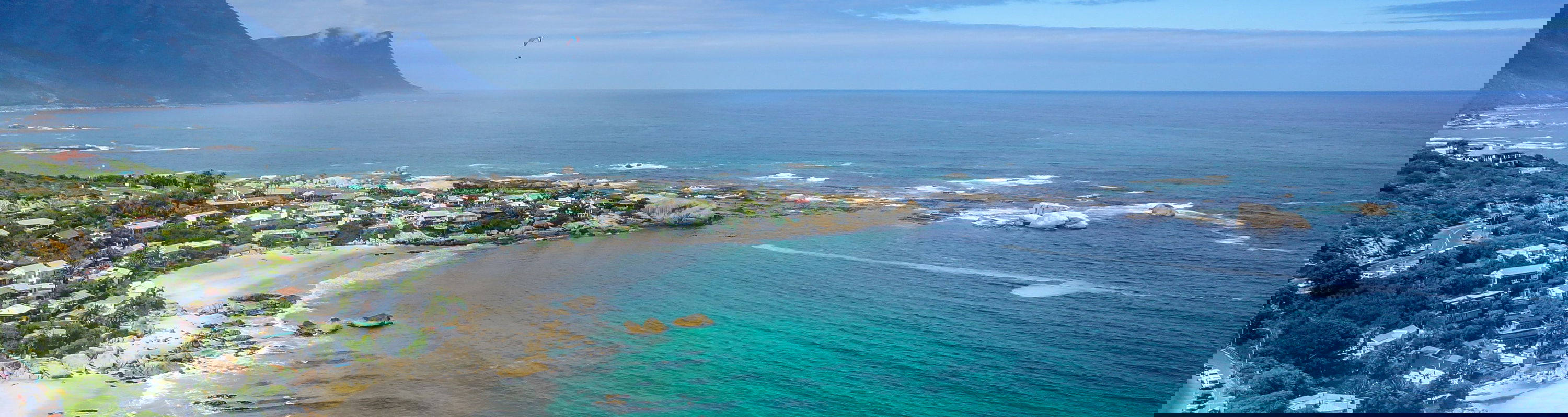 camps bay beach ariel view with mountains and sea in backdrop