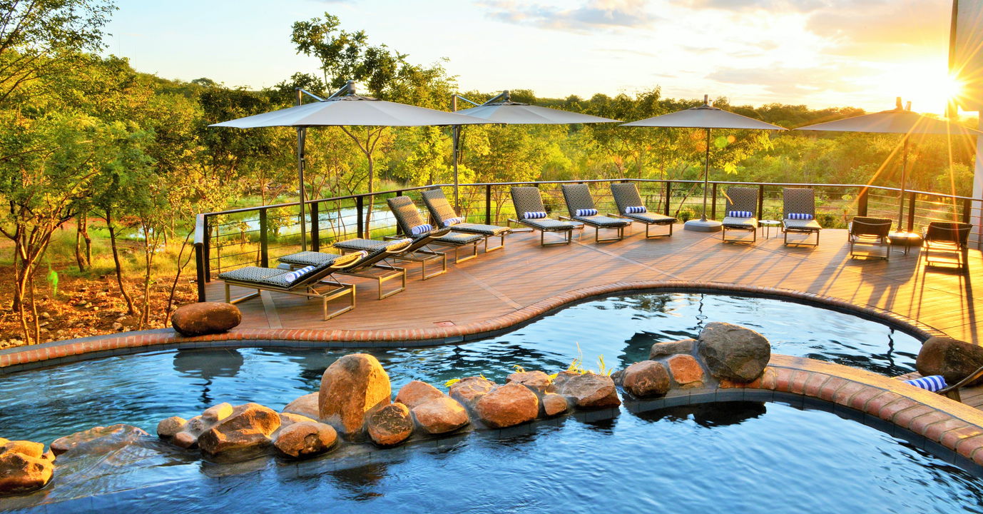 raised pool deck with loungers at Victoria falls safari lodge Zimbabwe
