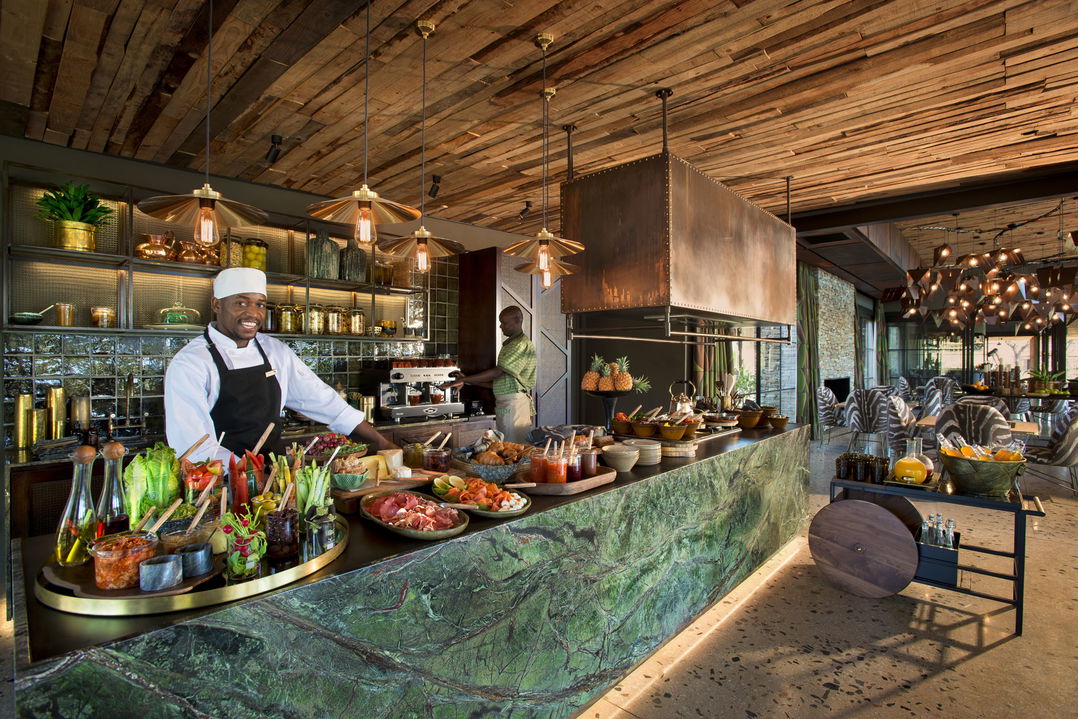 chef at counter with food spread at &Beyond Tengile River Lodge Sabi Sands