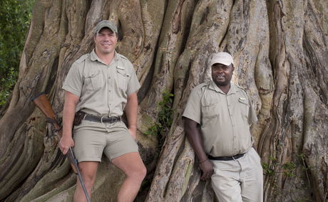 two rangers standing by tree at &Beyond Tengile River Lodge Sabi Sands two rangers standing by tree at &Beyond Tengile River Lodge Sabi Sands