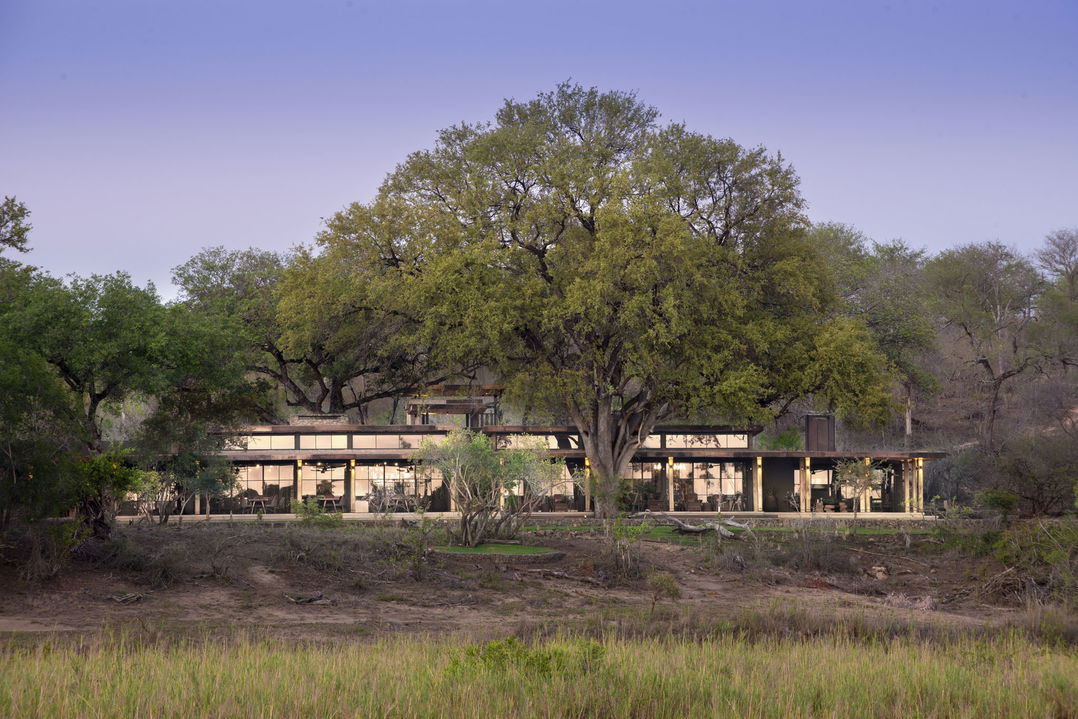 outside view of lodge facility from river at &Beyond Tengile River Lodge Sabi Sands