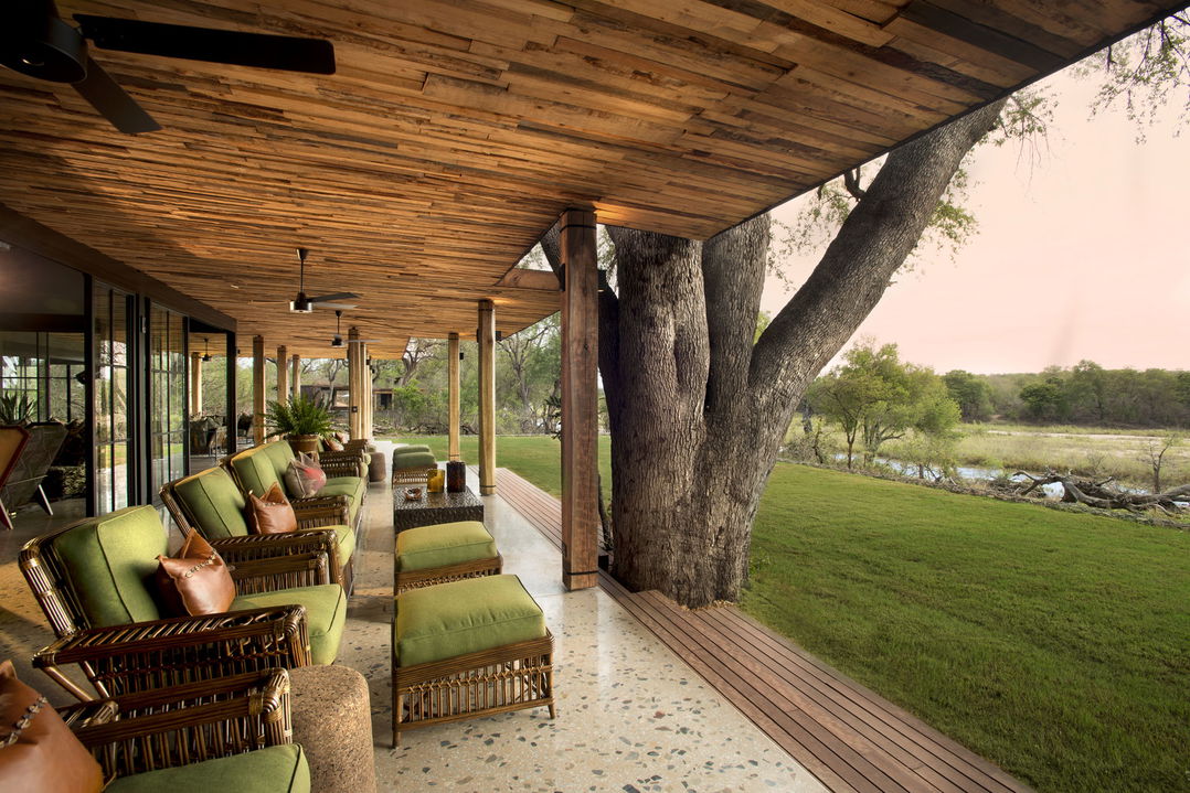 outside view of deck with loungers at &Beyond Tengile River Lodge Sabi Sands