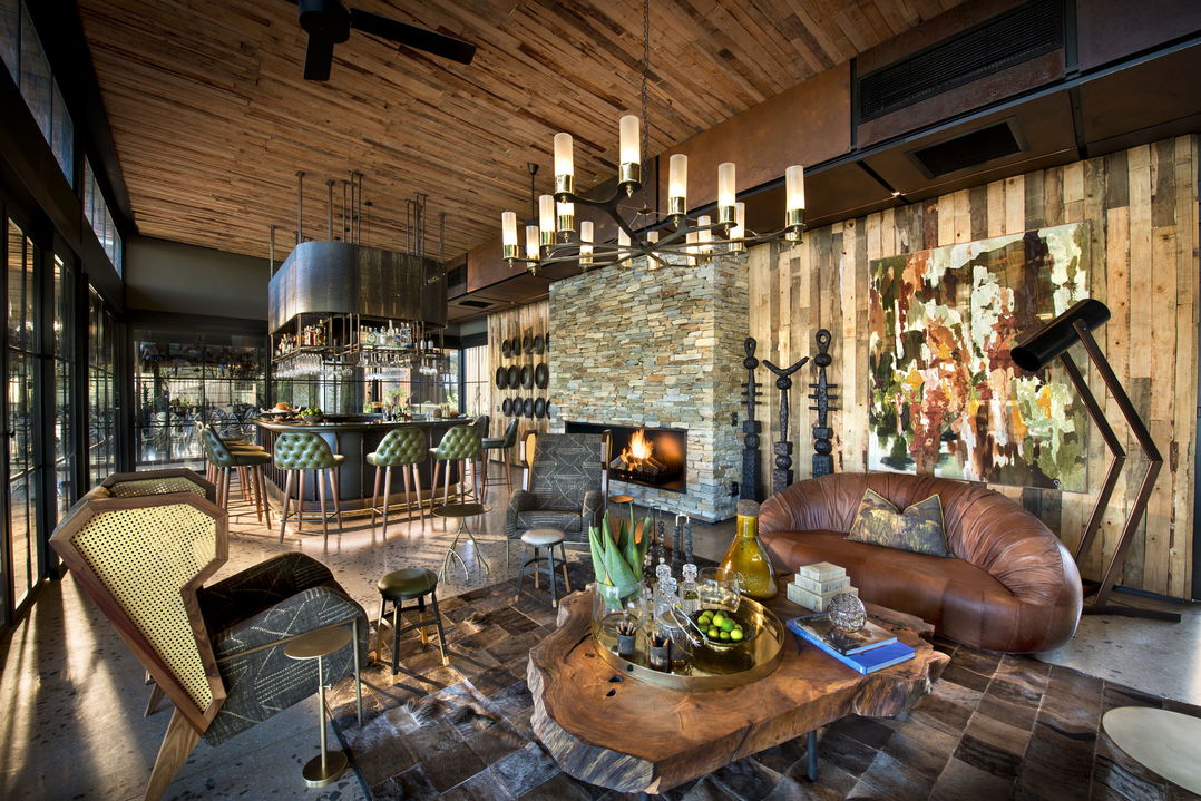 fireplace in lounge of main lodge at &Beyond Tengile River Lodge Sabi Sands