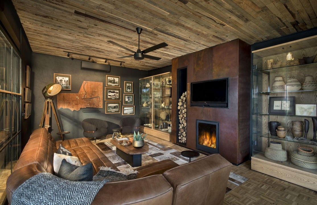 fireplace in lounge at &Beyond Tengile River Lodge Sabi Sands