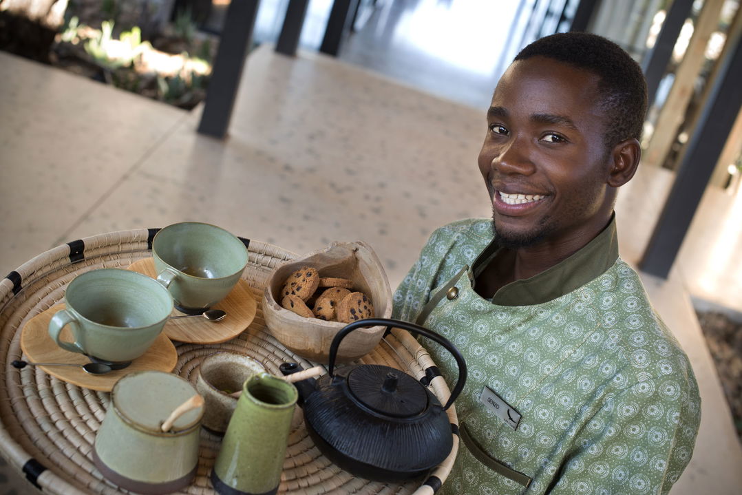 staff member serving coffee and rusks at Tengile River lodge
