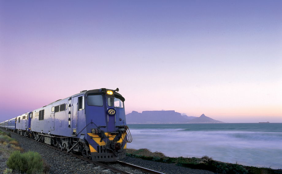 blue train on track with cape town and table mountain beyond blue train on track with cape town and table mountain beyond