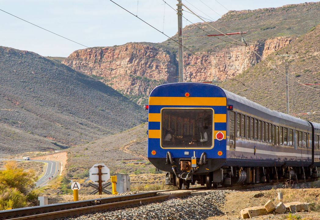 rear view of Blue Train traveling through mountains in South Africa