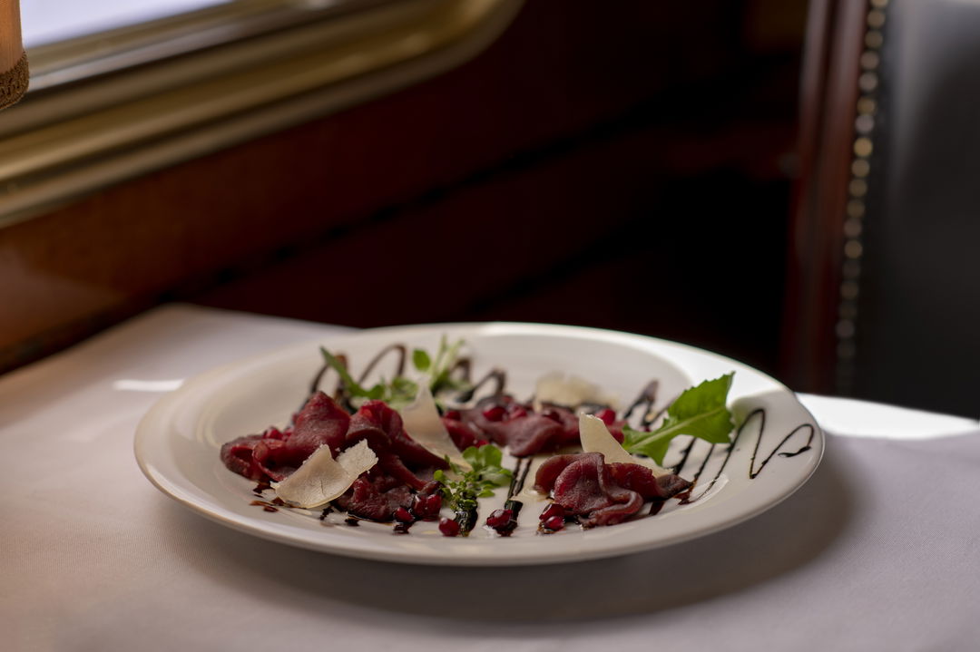 gourmet carpaccio on white plate served by Blue Train South Africa