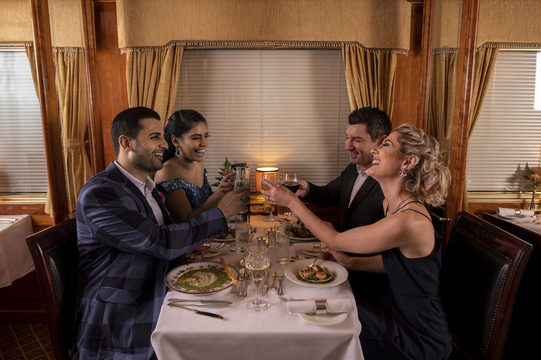 two couples toasting and having supper on the Blue Train South Africa
