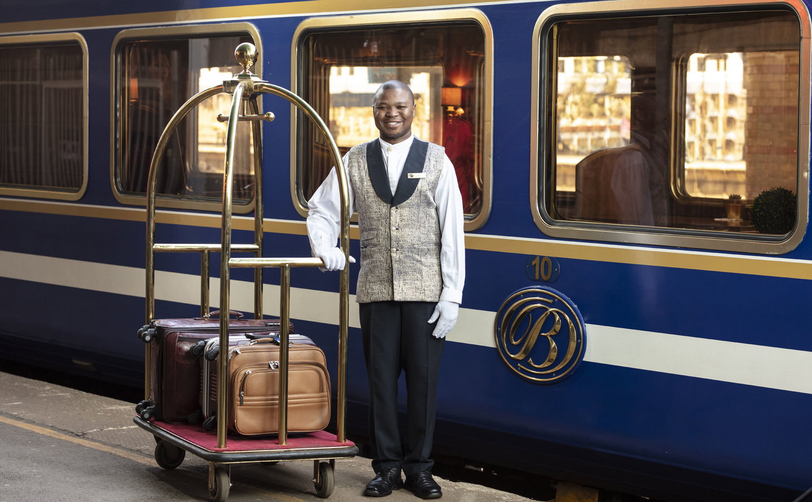 butler with luggage on platform of the blue train Pretoria